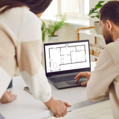 Couple Viewing Floor Plan on Computer Screen